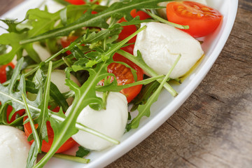 salad with mozzarella cherry tomatoes and arugula
