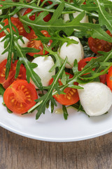 salad with mozzarella cherry tomatoes and arugula