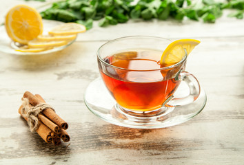 Glass cup of tea on a wooden table.