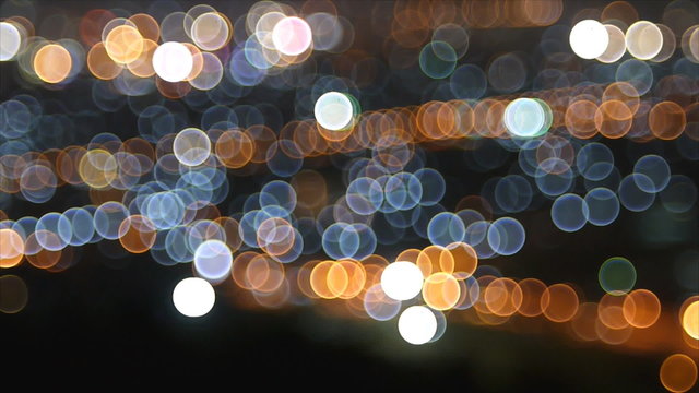 Bokeh of city at night by defocus lighting of building and traff