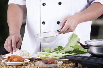 Chef present noodle with noodle soup ingredient