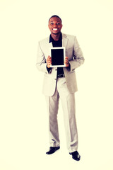 Happy businessman holding digital tablet.