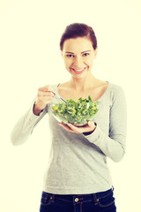 Woman eating lettuce.