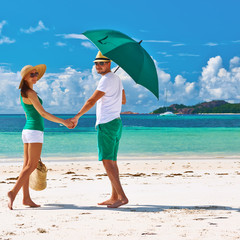 Couple in green on a beach at Seychelles