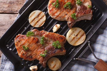 Grilled pork steak  in a pan grill closeup, horizontal top view