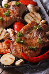 pork steak with vegetables on  grill. vertical top view macro