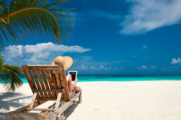 Young woman with tablet pc at the beach