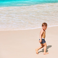 Fototapeta na wymiar Two year old boy playing on beach