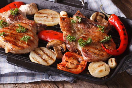 Grilled steak with mushrooms and peppers on grill. horizontal