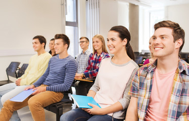 group of smiling students in lecture hall