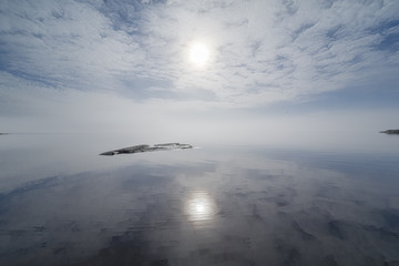 Fototapeta na wymiar Reflection of the sky in the misty lake.