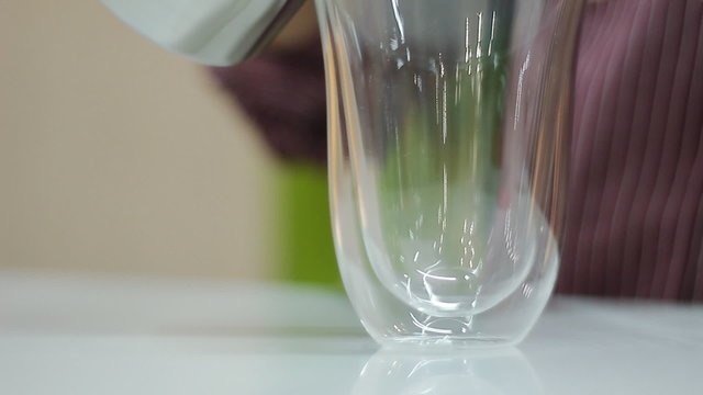 hot milk is poured into a glass