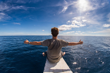 King of the sea (Man siting on a boat in the ocean)