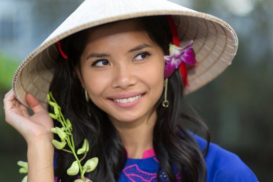 Pretty Vietnamese woman with a flower in her hair