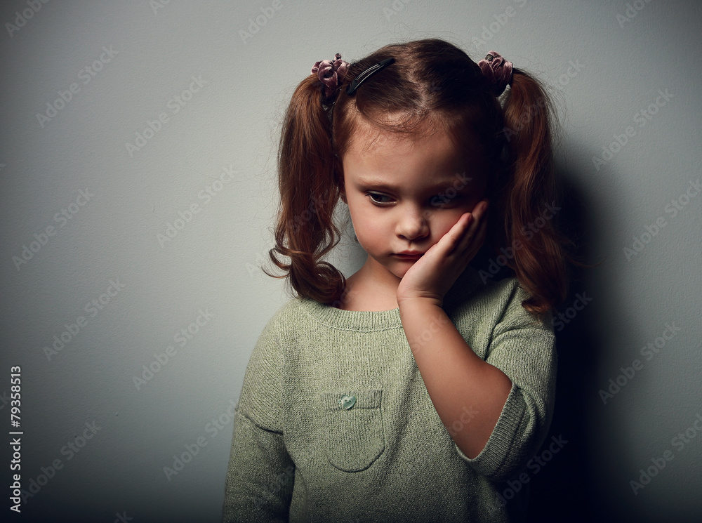 Wall mural Sadness kid girl looking unhappy. Closeup portrait