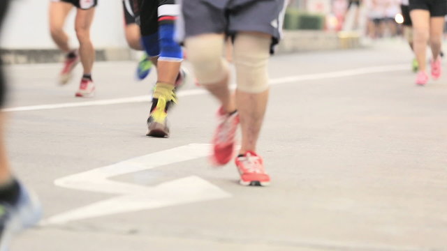 Marathon runners legs on the street 