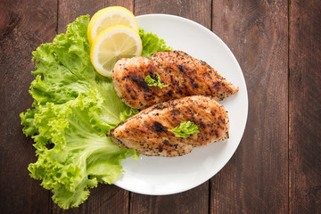 Marinated grilled chicken breasts cooked BBQ and served with fre