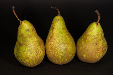 Green pears isolated from black background