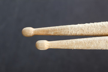 pair of drumsticks against dark blue background