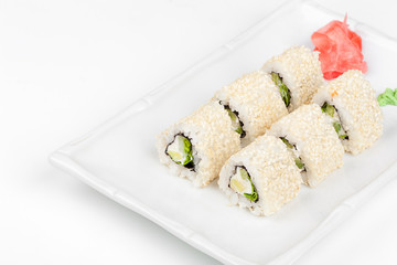 Three-cornered sushi roll with fish, cucumber and green salad.