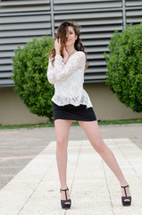 Fashion in a tiled garden with a bushes in the background