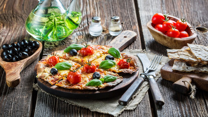 Closeup of homemade pizza with tomato and basil