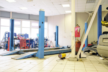 Image of a car repair garage with lift