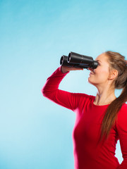 Woman looking through binoculars