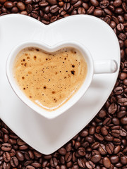 white coffee cup heart shaped with cappucino