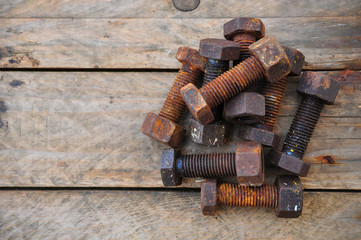 Old bolts or dirty bolts on wooden background