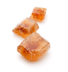 Brown caramelized lump cane sugar cube isolated on white backgro