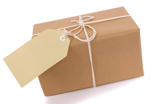 Brown paper package with white string and tag isolated on white background photo