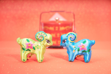 chinese goat toy on red background