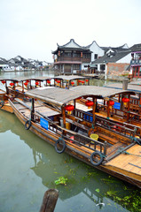 Fototapeta na wymiar Old village by river in Shanghai with boat..