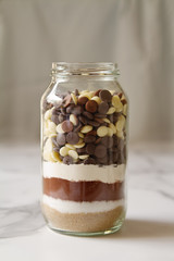 Chocolate brownie ingredients in a glass jar