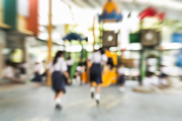 Blurred schoolgirls are playing in the playground