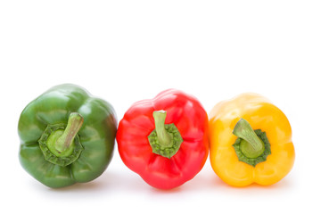 green and red and yellow bell peppers on a white background