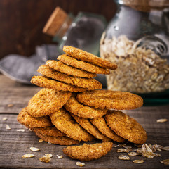 Thin oatmeal cookies crackers on a wooden dark background
