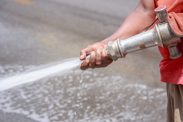 Street sprayed clean with pressurized water, wet cleaning of str