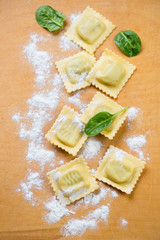 Raw ravioli with ricotta and spinach, above view, studio shot