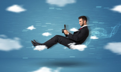 Funny racedriver young man driving between clouds concept