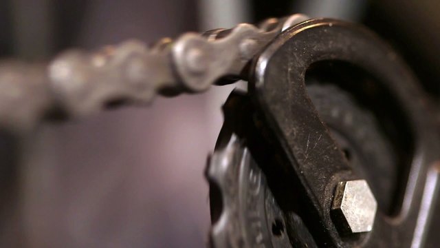 Dirty greasy gear chain linkage turning around in circle