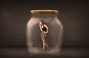 Businesswoman captured in a glass jar concept