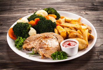 Steak, baked potatoes and vegetables