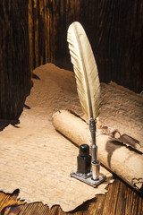 Vintage golden pen and ancient manuscripts
