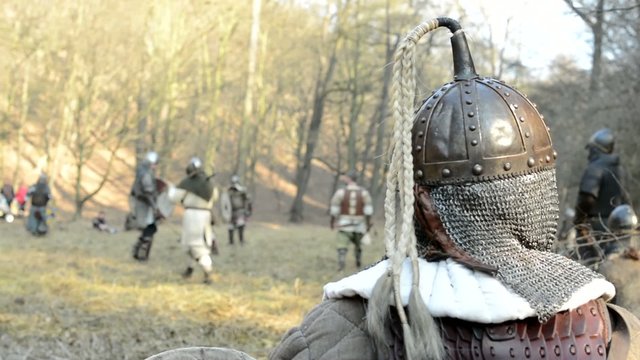 medieval battle - war - soldier watches other soldiers