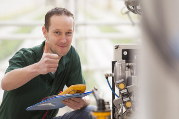 Male technician repairing agriculture machinery