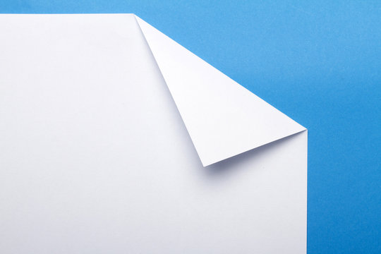 White piece of paper over a blue background.