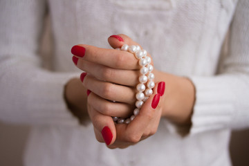 Pearls in female hands