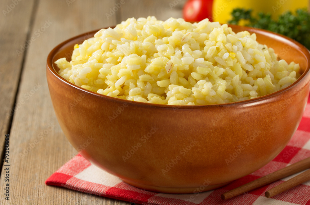 Poster bowl full of rice on wood